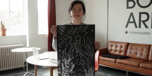 Jyn-San Tsang holding up her artwork for Cabot Conversations
